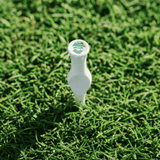 White golf tee on a grassy background